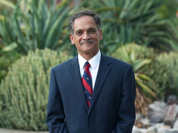 President Garimella poses outdoors on the University of Arizona campus