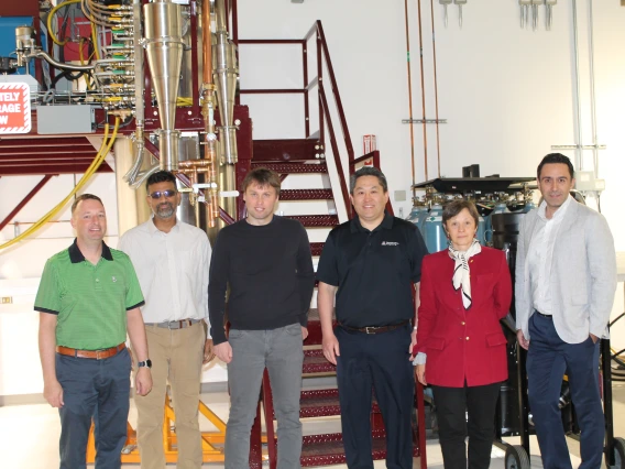 Researchers pose in an Applied Research Building lab.