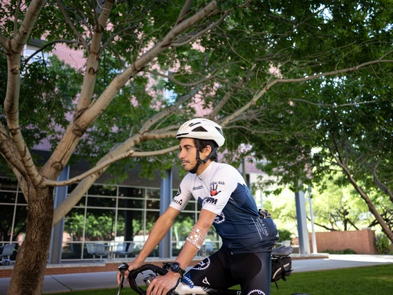 A cyclist riding outdoors models the device