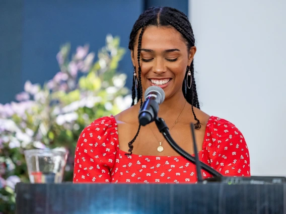 Aaliyah Thompson-Mazzeo speaks at a podium.