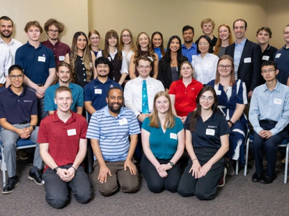 A large group of students and teaching assistants poses in the SUMC on the University of Arizona campus.