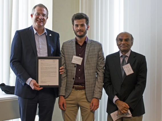 Sayyed Mohsen Vazirizade, outstanding graduate student in civil engineering and engineering management, with nominator Achintya Haldar and Craig M. Berge Dean David Hahn.