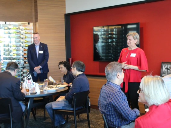 Liesl Folks and Mark Van Dyke stand and speak to the group.