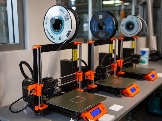 A row of 3D printers in the new lab.