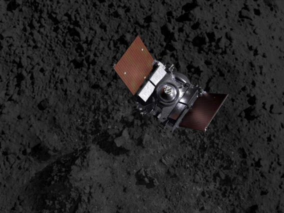 A spacecraft above an asteroid's terrain (artist's impression).