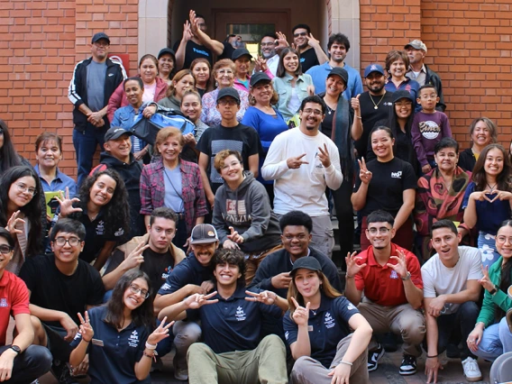 Students and event participants pose for a photo in the Old Engineering Building courtyard.