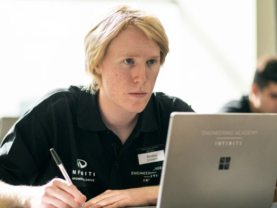 Andre Schreiber looking intently at a laptop screen.