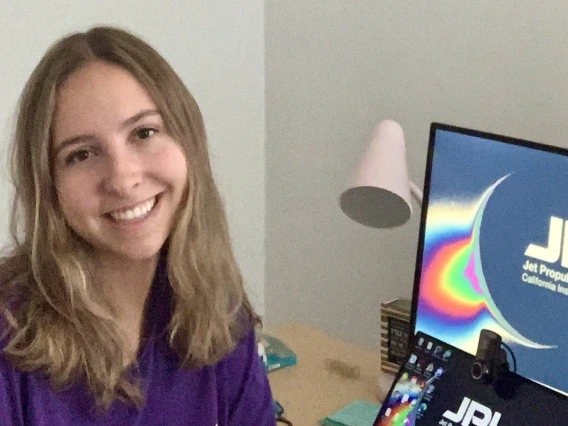 Ariel Shaver next to a NASA JPL computer.