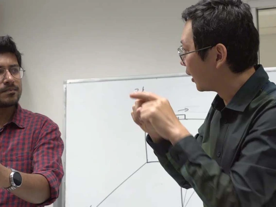 two faculty members work with radar equipment in a classroom