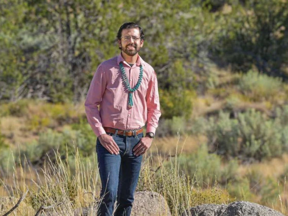 Dylan Moriarty, outdoors, thumbs in his jean pockets.