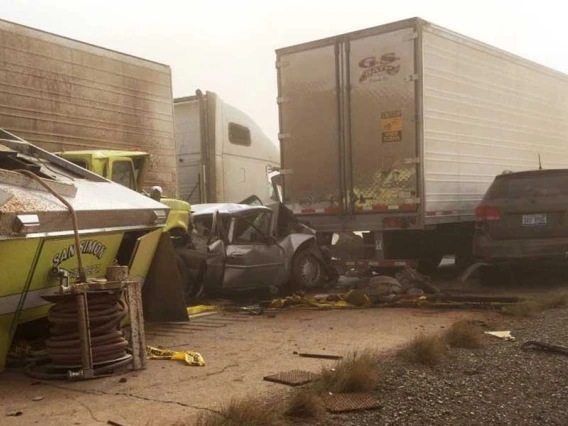 A multicar accident on a dusty roadside