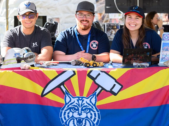 Students sit at an expo table