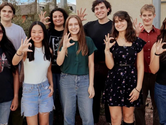 nine students pose outdoors