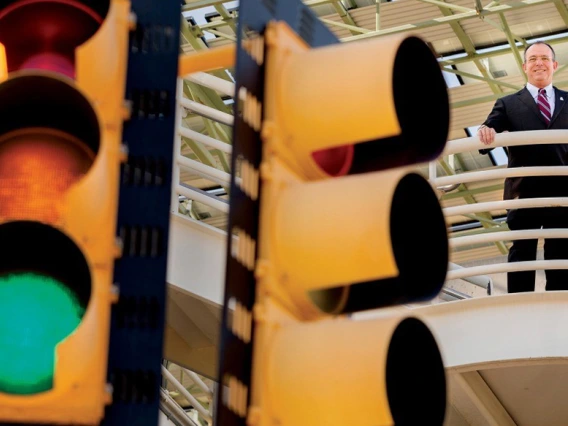 Larry Head stands behind traffic lights