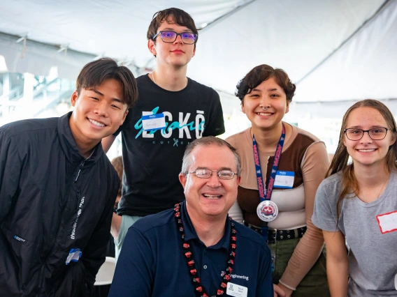 Dean David Hahn poses for a photo with four incoming engineering students