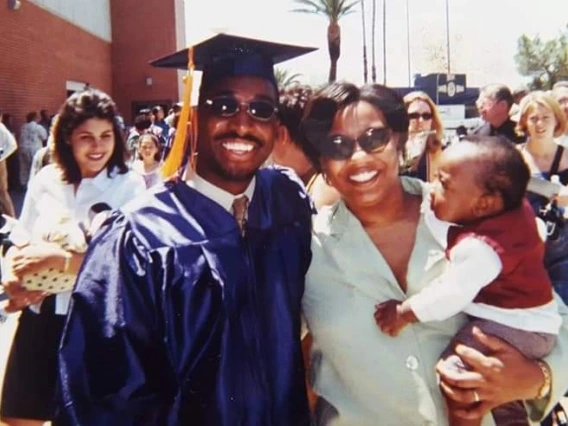 Brian Mushimba with his wife & son at his UA graduation.