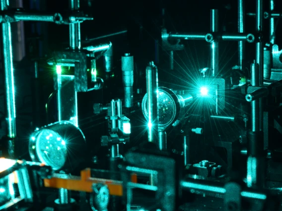 A setup in a materials science and engineering laboratory, lit with dim blue light.