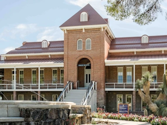 Photo of Old Main taken from the west, with the fountain in the foreground.