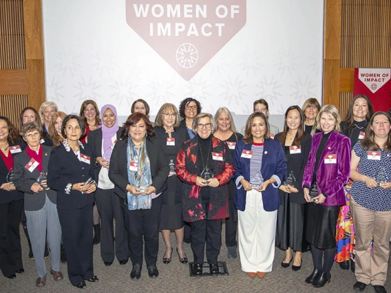 all awardees pose under a banner