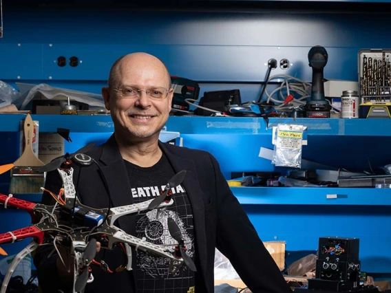 Wolfgang Fink poses with a planetary rover