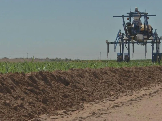 A high-tech tractor-type vehicle moves across a field.