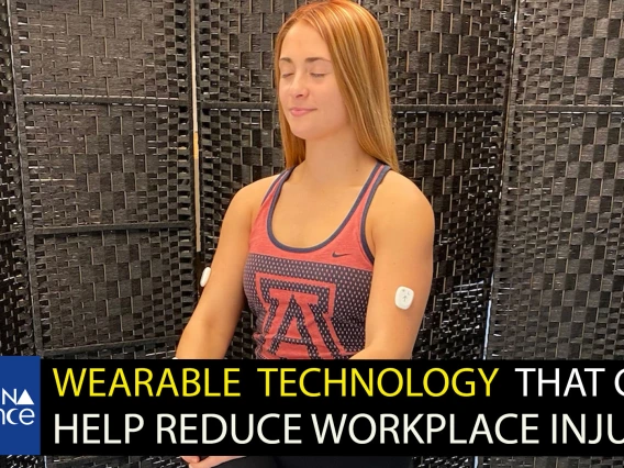 A young woman wearing a University of Arizona tanktop and wearing a white sensor on each bicep. Text on bottom third reads, "Wearable technology that can help reduce workplace injury."