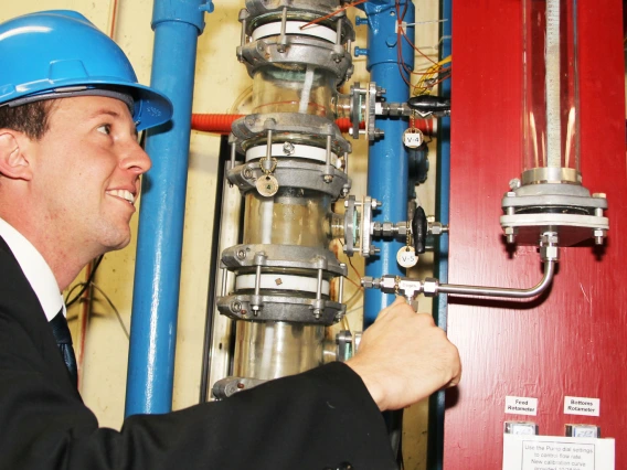 man inspecting water pipes