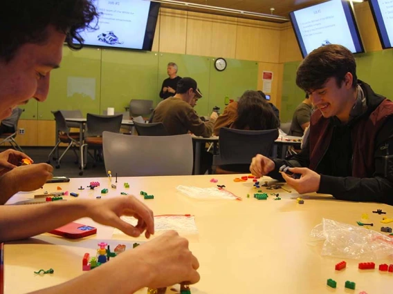 Students work with Lego blocks in a classroom