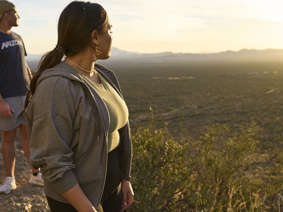 Two students gaze at the desert landscape