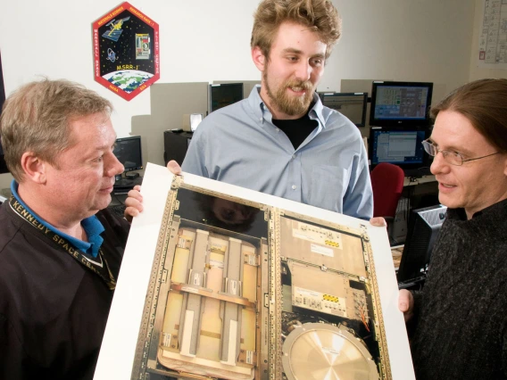 engineers examine test equipment