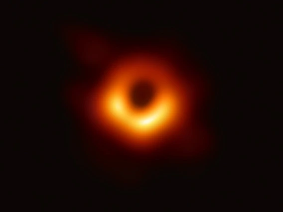 Photo of a black hole -- it looks like an orange ring surrounded by blackness