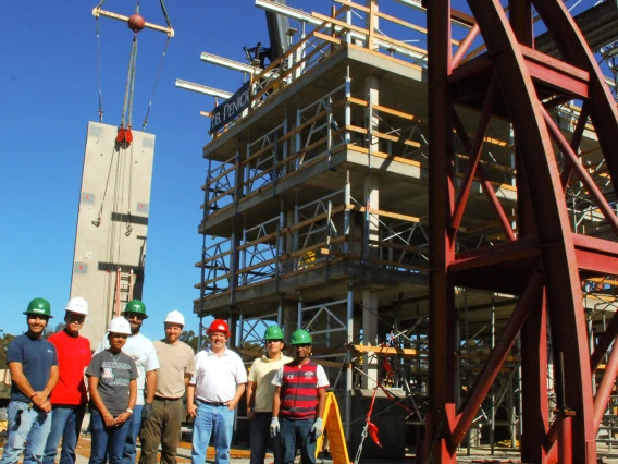 engineers standing next to giant earthquake test rig
