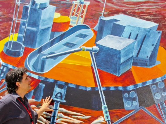 professor studies space mural