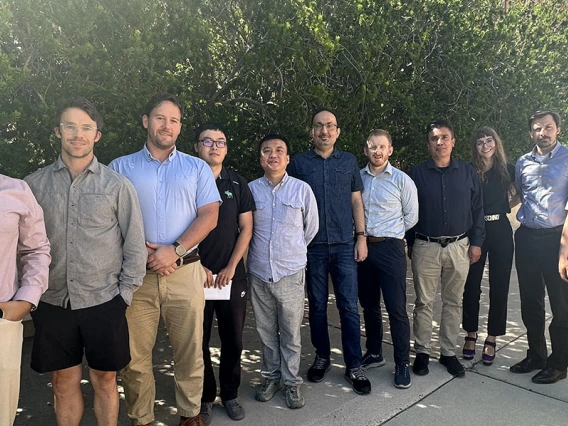 a large group of instructors poses outdoors