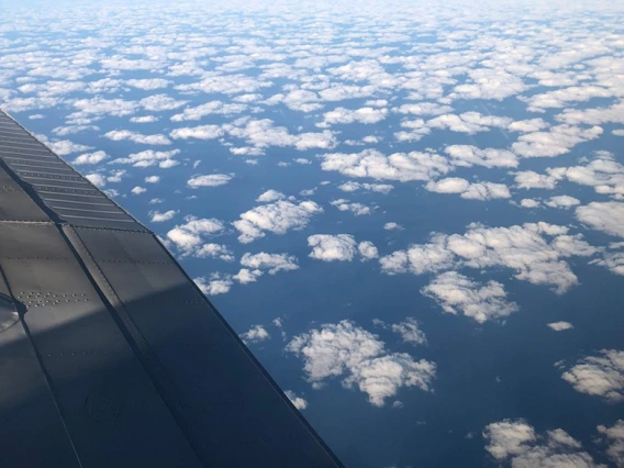 a view of clouds and an airplane wing