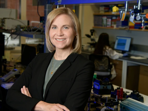 Jennifer Barton, professionally posed and smiling in a biomedical lab.