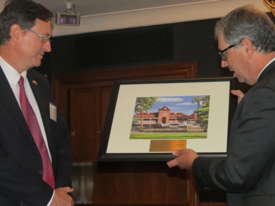 Jeff Goldberg hands plaque to Roman Macaya