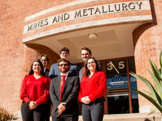 Five students stand on the front steps of the Mines and Metallurgy building.