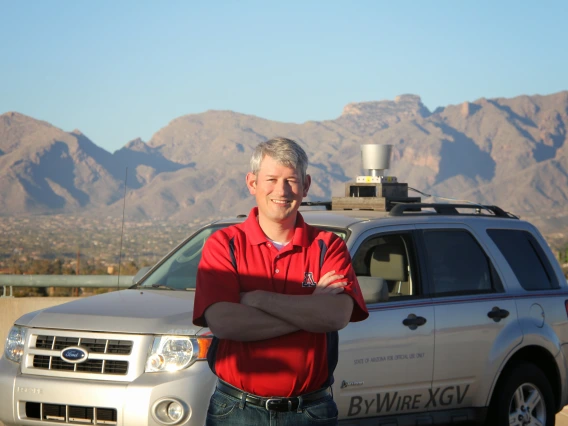 Jonathan Sprinkle in front of the CAT Vehicle