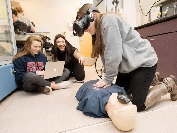 UA engineering students fine-tune their virtual reality system for CPR training after hours on the floor of a lab at the Sarver Heart Center.