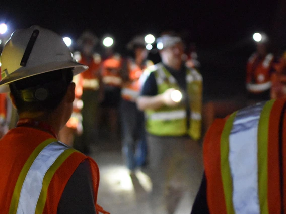 a group of students tour a dark mine