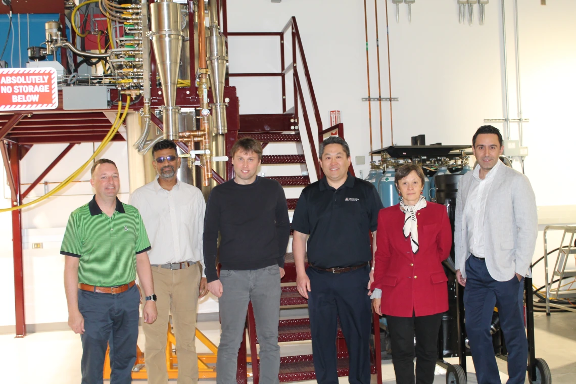 Researchers pose in an Applied Research Building lab.