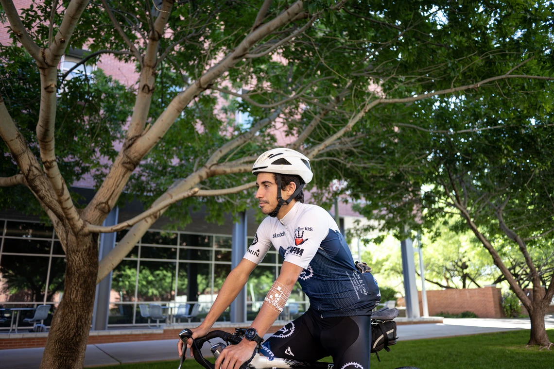 A cyclist riding outdoors models the device