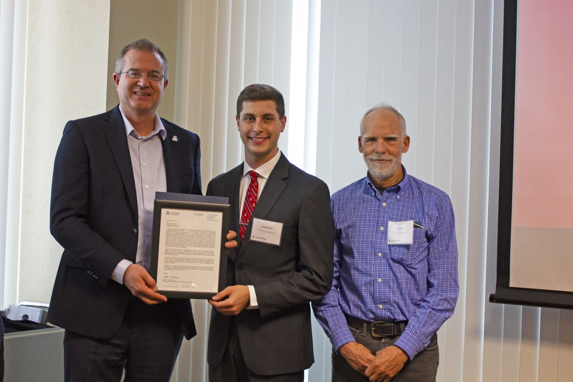 Josh Pace, outstanding senior in biomedical engineering, with nominator Art Gmitro and Craig M. Berge Dean David Hahn.