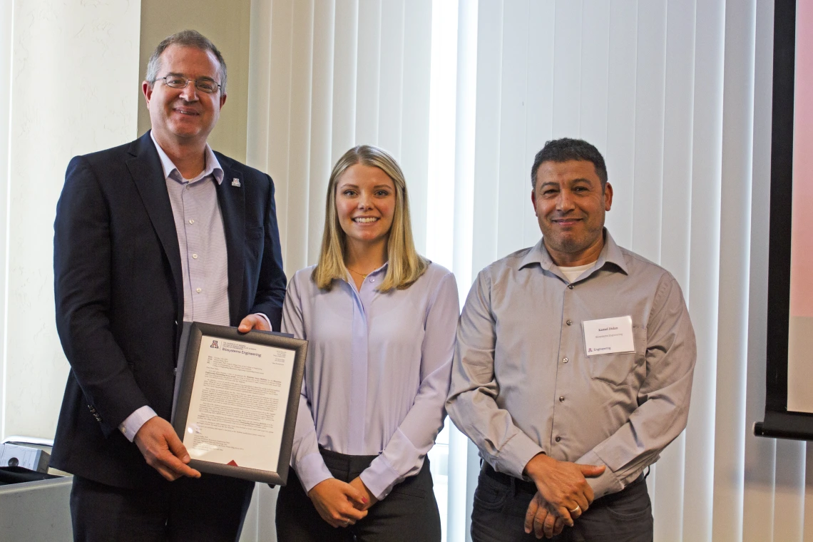 Madeline Melichar, outstanding senior in biosystems engineering, with nominator Kamel Didan and Craig M. Berge Dean David Hahn.