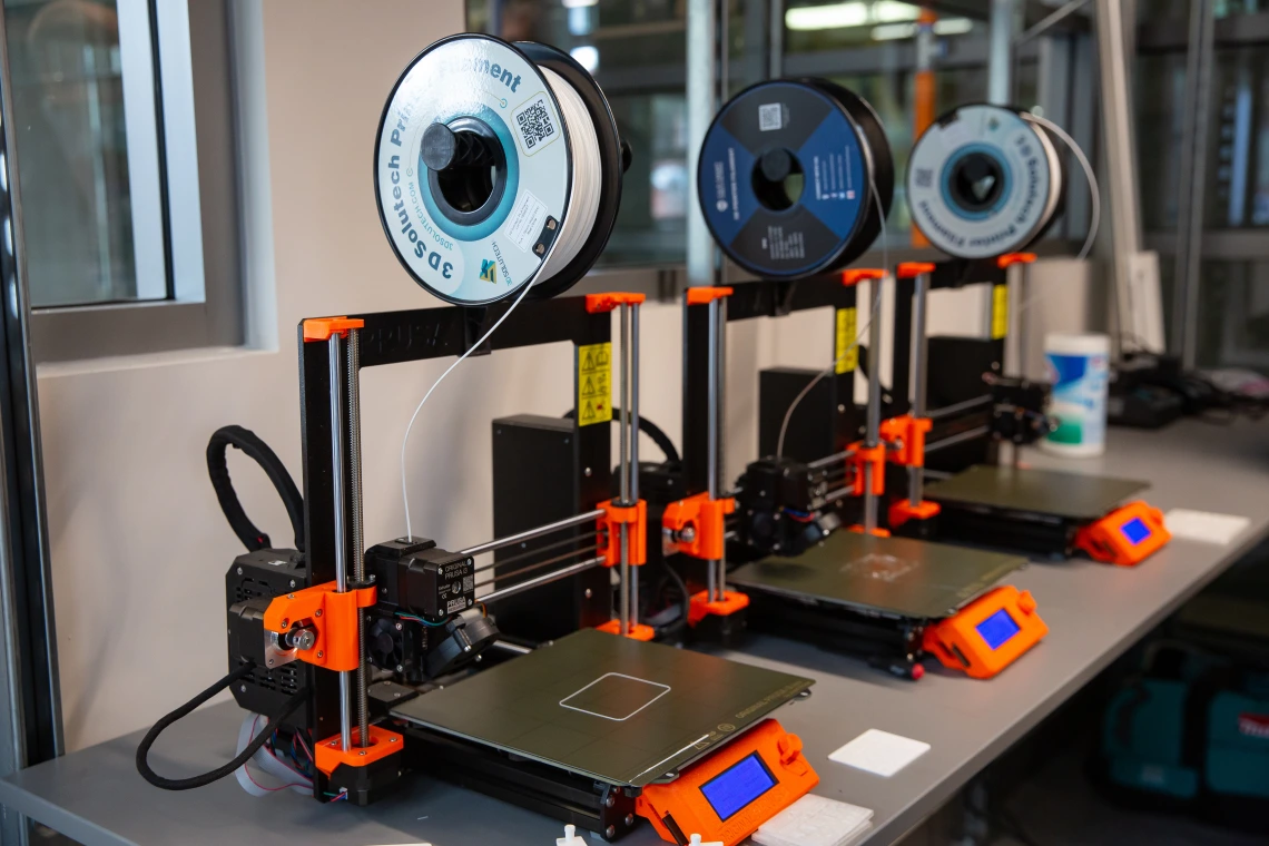 A row of 3D printers in the new lab.