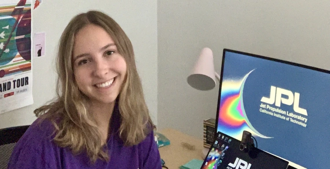 Ariel Shaver next to a NASA JPL computer.