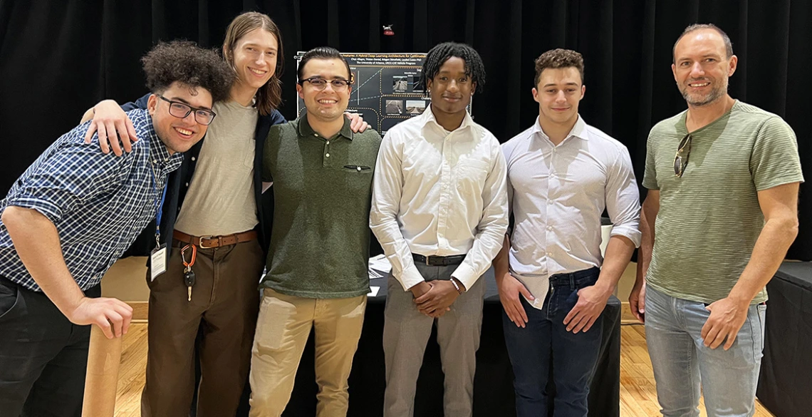 6 people stand in front of a research poster