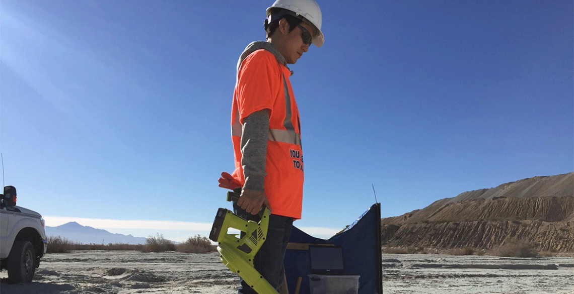 Taehee Lee applies a blower to the desert dirt.