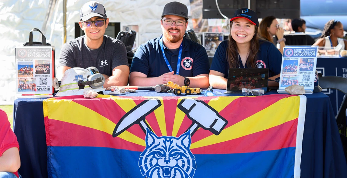 Students sit at an expo table